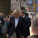 Senator Chuck Schumer smiling with a group of people