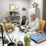 Two interns smiling in the Advokate office. Bella on the left and Sarah on the right.