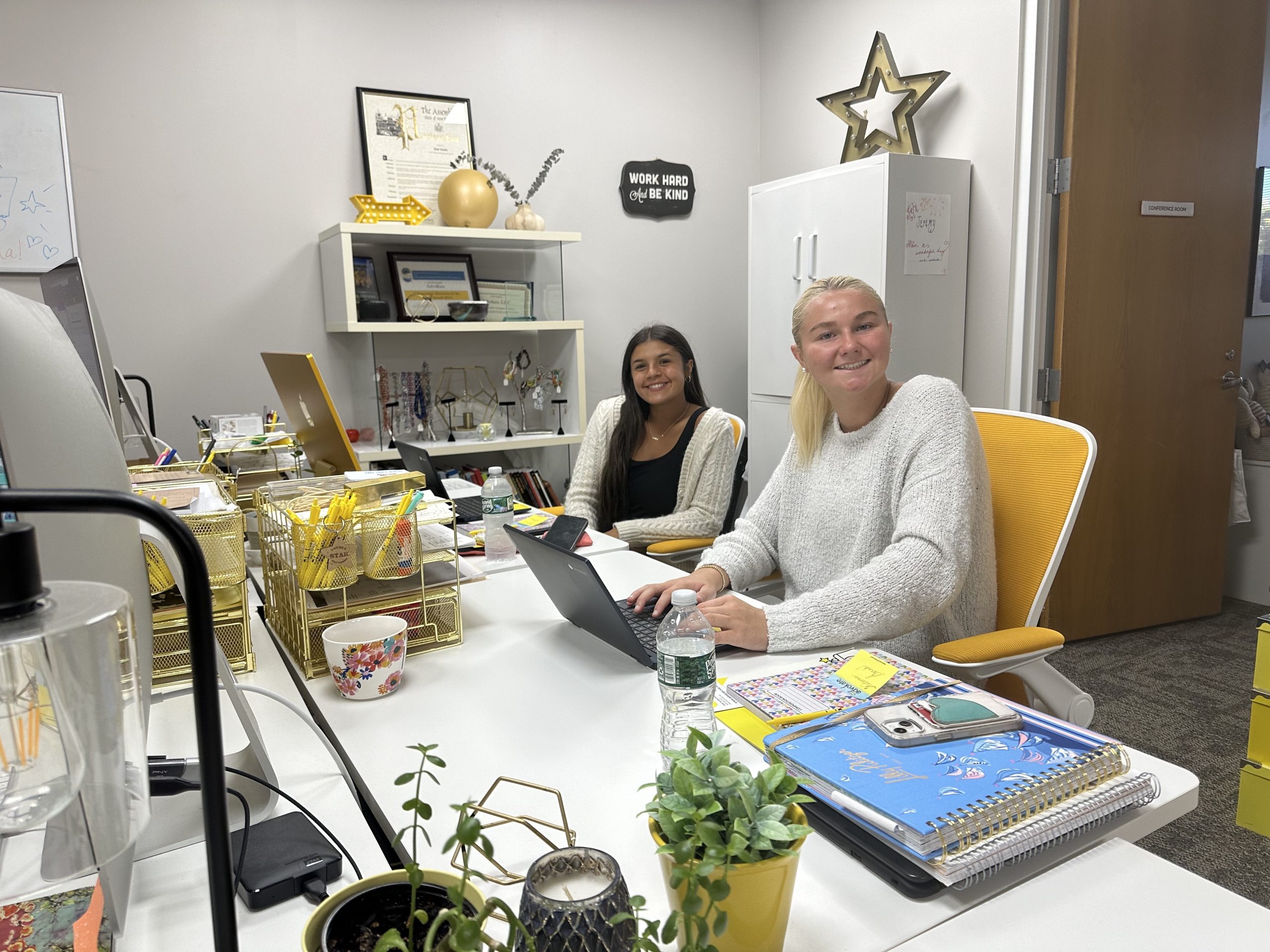 Two interns smiling in the Advokate office. Bella on the left and Sarah on the right.